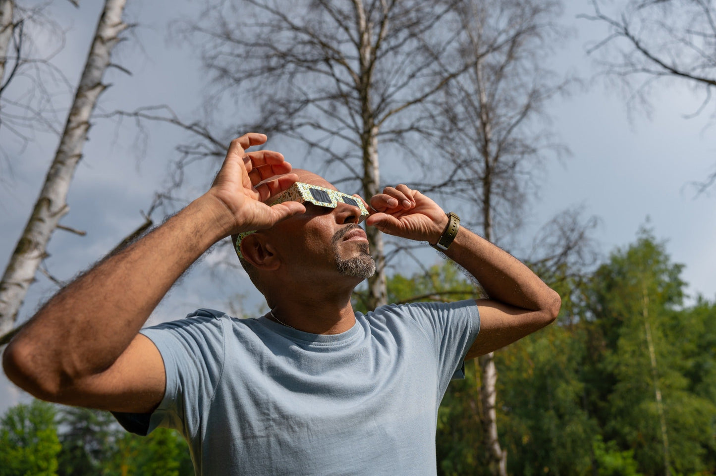 Person adjusting Tember Avocado solar eclipse glasses